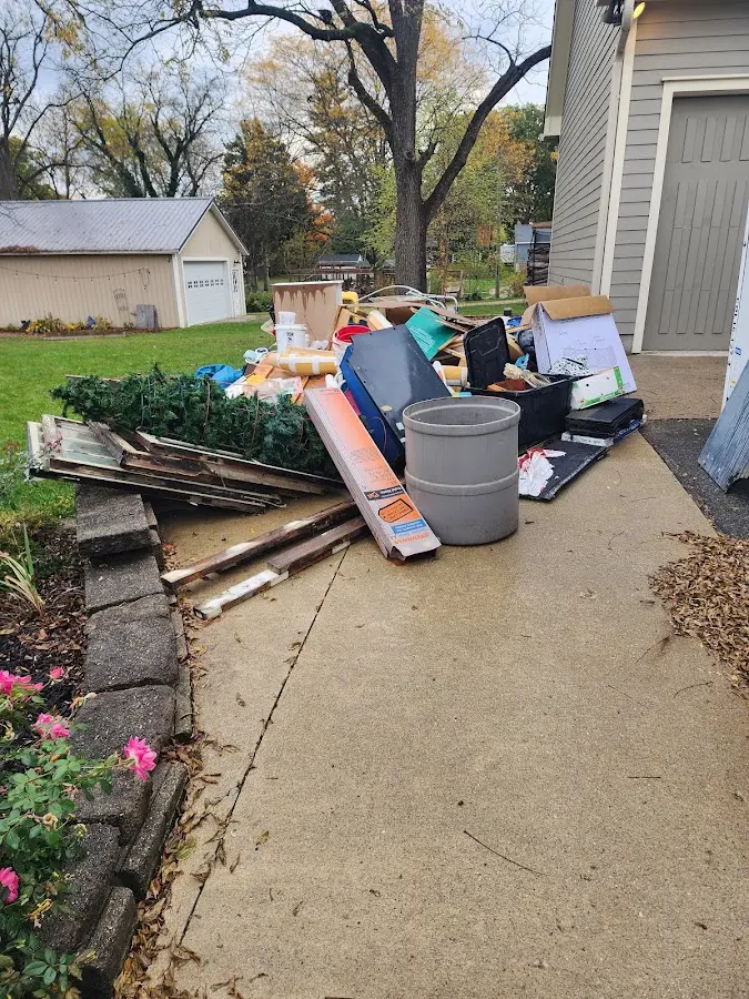 Dumpster being loaded with debris for Roofing Dumpster Rental in High Ridge